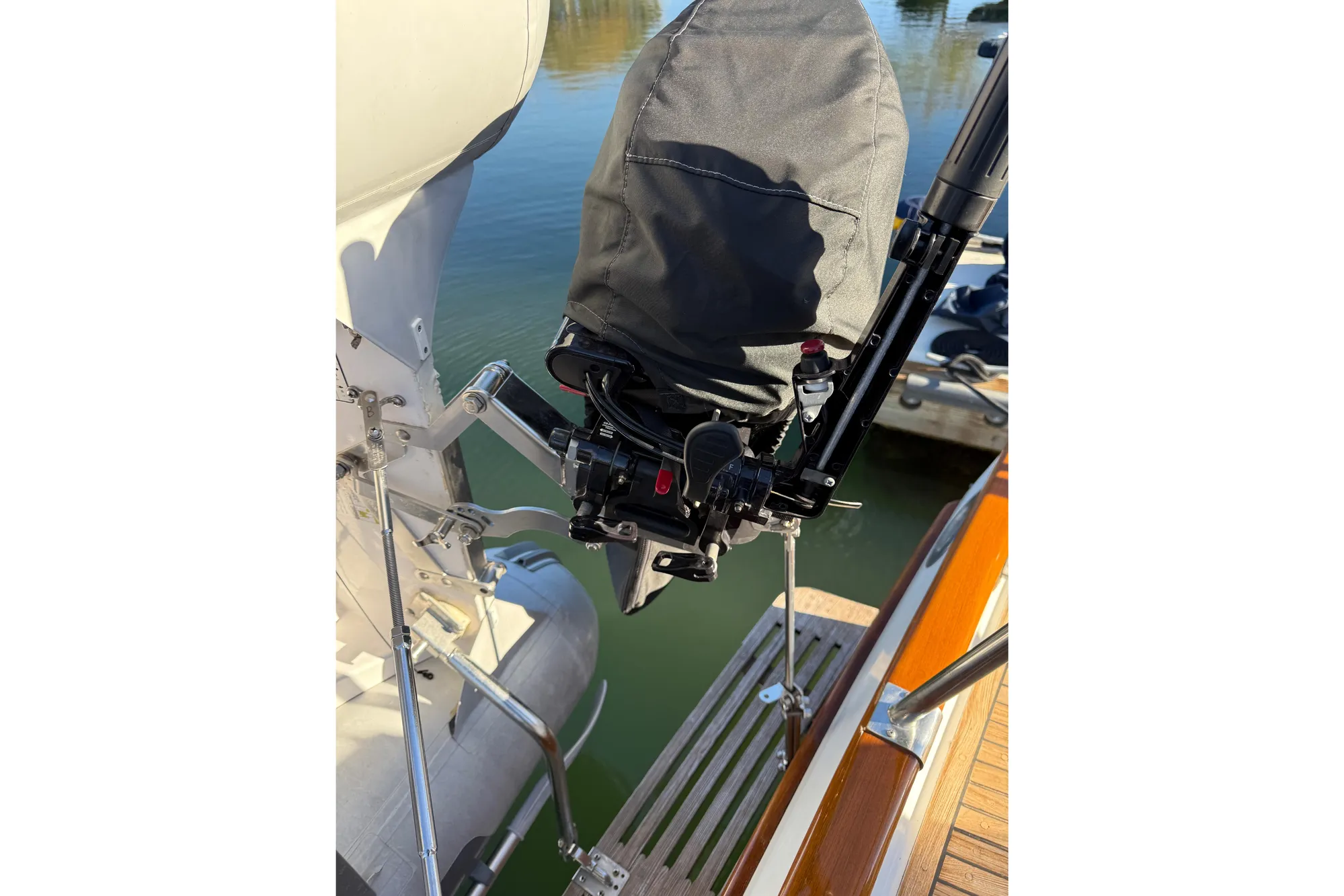 1997 Grand Banks Classic boat with covered outboard motor and wooden deck detail.