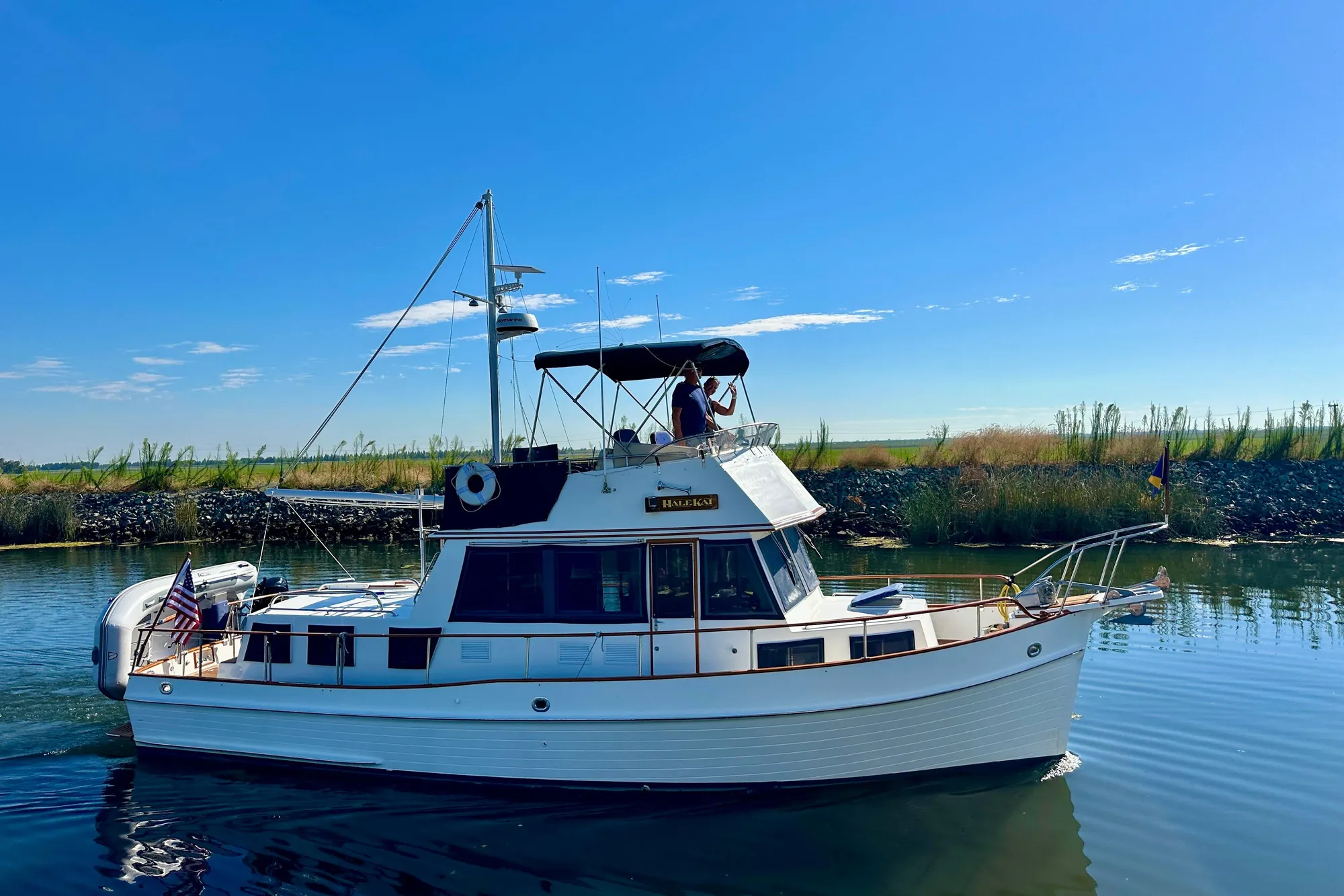 1997 Grand Banks Classic yacht cruising on a sunny day, surrounded by calm waters.