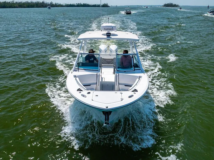  Yacht Photos Pics 2021 Blackfin 272 DC boat cruising on open water, viewed from the front.