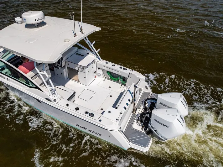  Yacht Photos Pics 2021 Blackfin 272 DC boat with twin Mercury engines cruising on water.