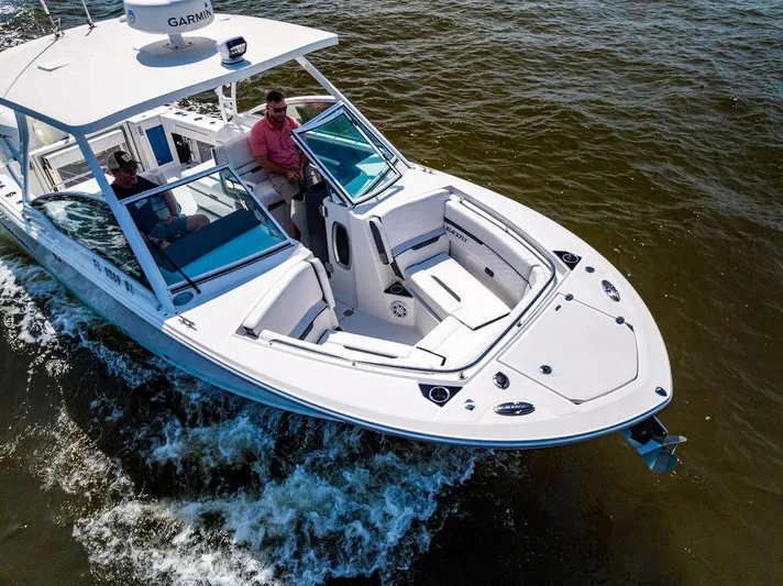  Yacht Photos Pics 2021 Blackfin 272 DC boat cruising on open water, featuring sleek design and modern amenities.