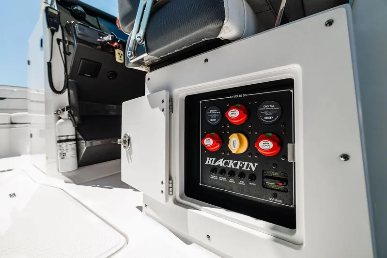  Yacht Photos Pics 2021 Blackfin 272 DC boat control panel with switches and fire extinguisher.