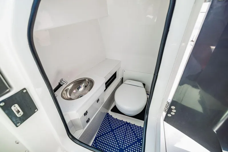  Yacht Photos Pics 2021 Blackfin 272 DC boat interior bathroom with sink and toilet.