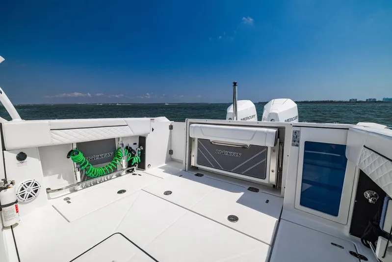  Yacht Photos Pics 2021 Blackfin 272 DC boat deck with ocean view, featuring storage compartments and twin engines.