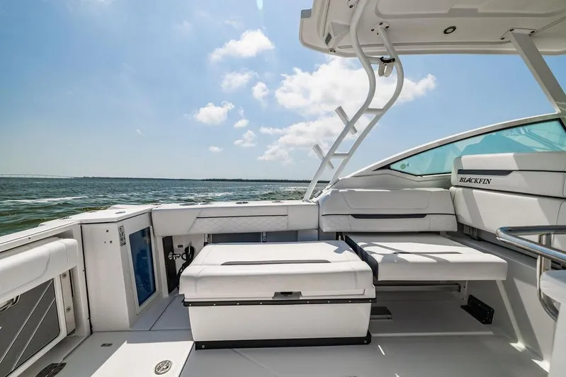 Yacht Photos Pics 2021 Blackfin 272 DC boat interior with seating, ocean view, and clear sky.