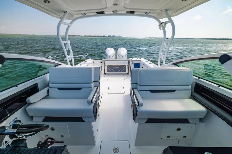  Yacht Photos Pics 2021 Blackfin 272 DC boat interior with seating, overlooking calm ocean waters.