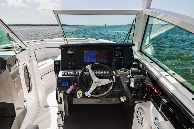  Yacht Photos Pics 2021 Blackfin 272 DC boat cockpit with modern navigation equipment and ocean view.