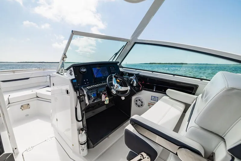  Yacht Photos Pics 2021 Blackfin 272 DC boat cockpit with modern controls and ocean view.