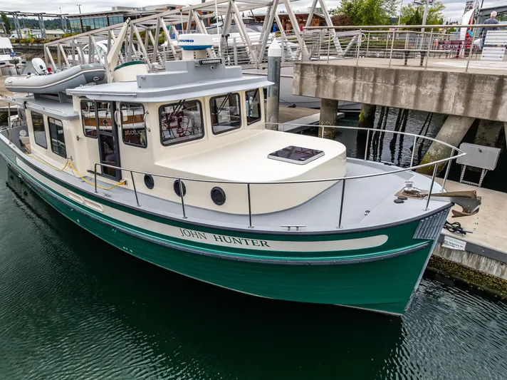 John Hunter Yacht Photos Pics Nordic Tug 37, 2000 model, docked at marina, green and white exterior.
