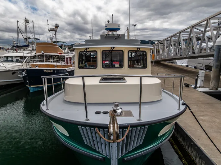 John Hunter Yacht Photos Pics Nordic Tug 37, 2000 model, docked at marina with overcast sky.