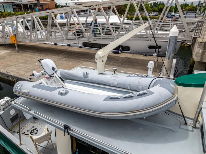 John Hunter Yacht Photos Pics Inflatable boat on 2000 Nordic Tug 37 at marina dock.