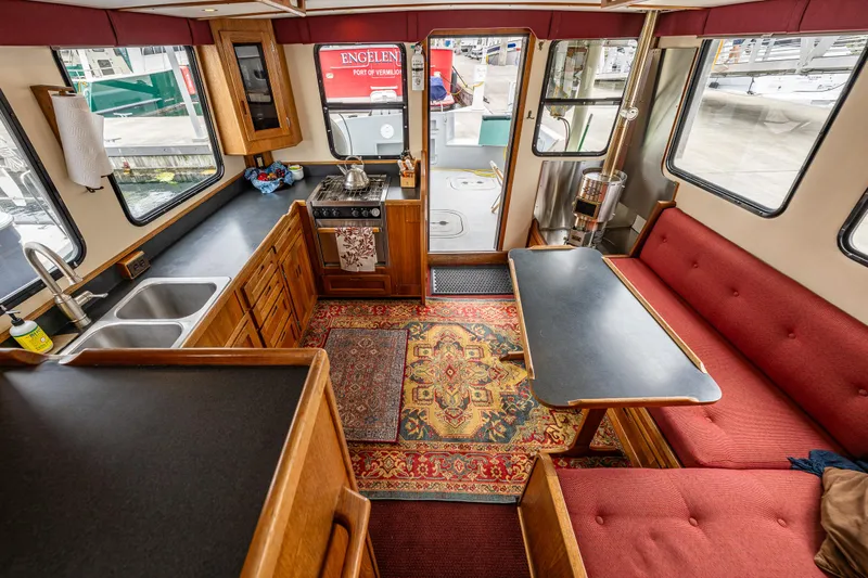 John Hunter Yacht Photos Pics Interior of a 2000 Nordic Tug 37, featuring a cozy kitchen and dining area.