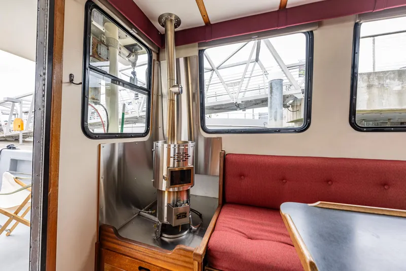 John Hunter Yacht Photos Pics Interior of a 2000 Nordic Tug 37 with a cozy seating area and stove.