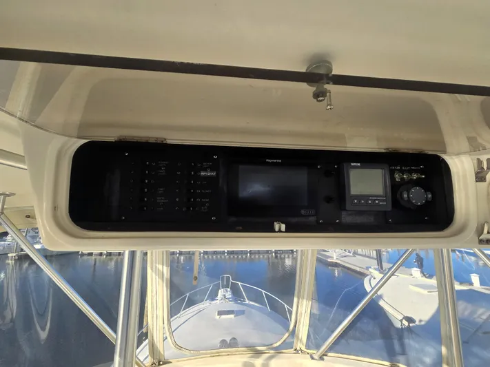 Relentless Yacht Photos Pics 2001 Ocean Yachts 43 Super Sport helm with navigation equipment and marina view.