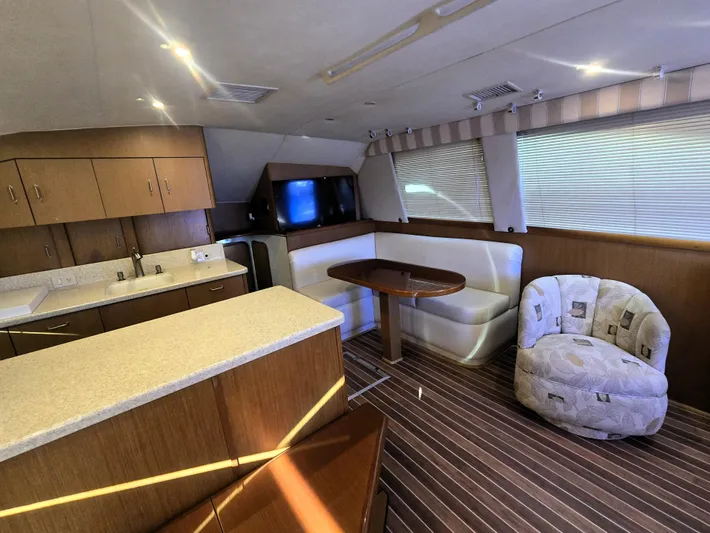 Relentless Yacht Photos Pics Interior of 2001 Ocean Yachts 43 Super Sport with modern kitchen and cozy seating area.