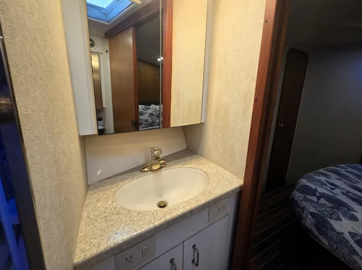 Relentless Yacht Photos Pics Bathroom vanity in 2001 Ocean Yachts 43 Super Sport, featuring a sink and mirror.