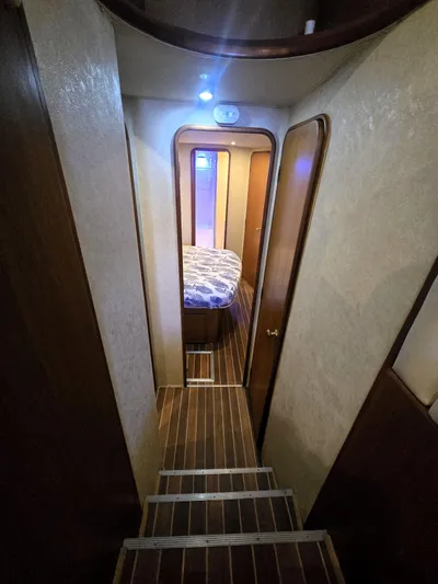 Relentless Yacht Photos Pics Interior hallway of 2001 Ocean Yachts 43 Super Sport with wood flooring and bedroom view.