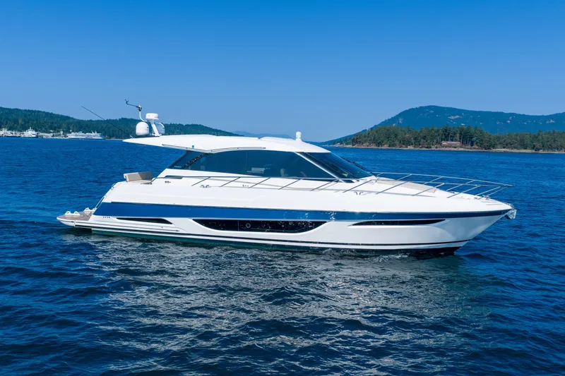 City Lights Yacht Photos Pics 2021 Maritimo X50 yacht cruising on blue water with scenic mountain backdrop.