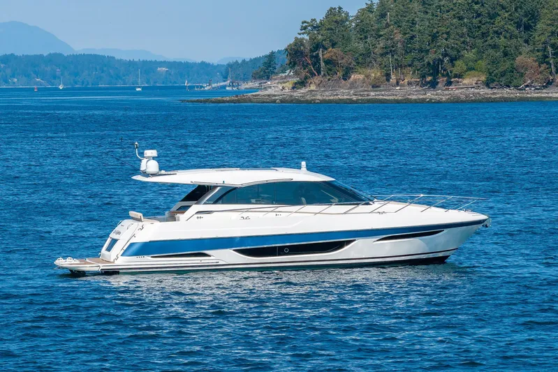 City Lights Yacht Photos Pics 2021 Maritimo X50 yacht cruising on blue ocean near forested shoreline.