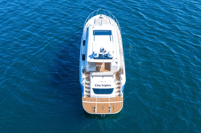 City Lights Yacht Photos Pics Aerial view of 2021 Maritimo X50 yacht named "City Lights" on blue ocean water.