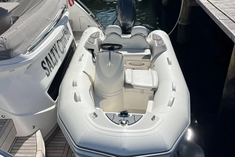 Salty Cowboy Yacht Photos Pics 2022 Princess F55 yacht with inflatable tender docked at marina.