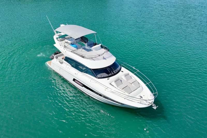  Yacht Photos Pics 2023 Prestige 460 Flybridge yacht cruising on turquoise waters.