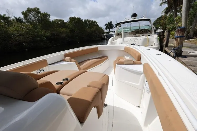 Bada Bing Yacht Photos Pics 2020 HCB 39 Speciale boat with tan seating, docked near lush greenery.