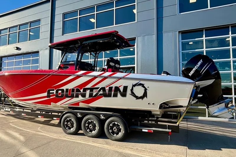  Yacht Photos Pics 2021 Fountain 38 SC boat with red and white design, parked on a trailer.