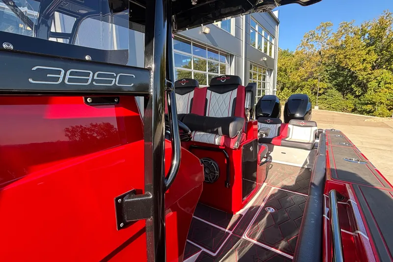  Yacht Photos Pics 2021 Fountain 38 SC boat interior with red and black seating, outdoor setting.