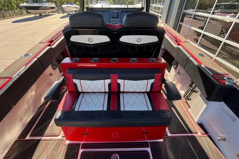 Yacht Photos Pics 2021 Fountain 38 SC boat interior with red and black seating, cup holders, and dashboard view.
