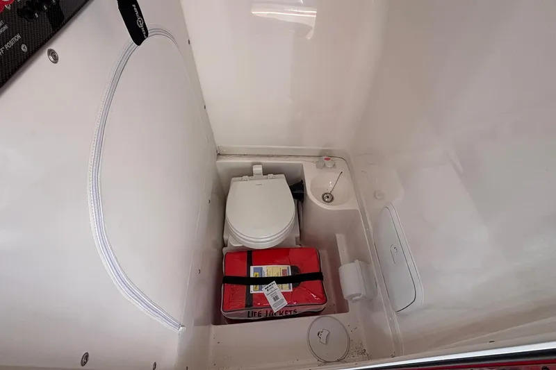  Yacht Photos Pics 2021 Fountain 38 SC boat interior with toilet and life jackets.