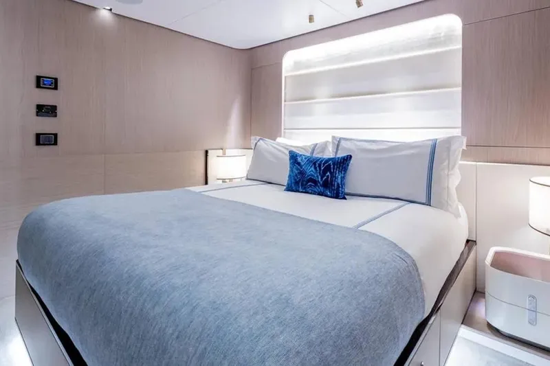  Yacht Photos Pics Luxurious bedroom interior of 2021 Azimut Grande 27 METRI yacht, featuring elegant bedding and modern lighting.