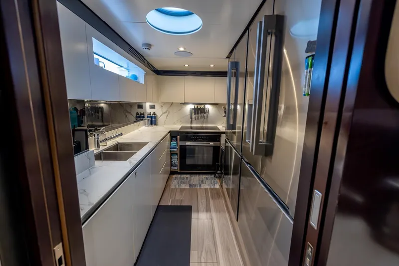  Yacht Photos Pics Luxurious kitchen interior of 2021 Azimut Grande 27 METRI yacht, featuring modern appliances and sleek design.
