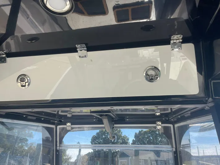 Yacht Photos Pics 2023 Cobia 320 CC boat interior with storage compartments and latches.