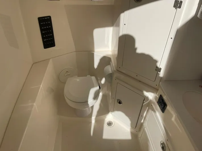  Yacht Photos Pics 2023 Cobia 320 CC boat interior with toilet and storage compartments.