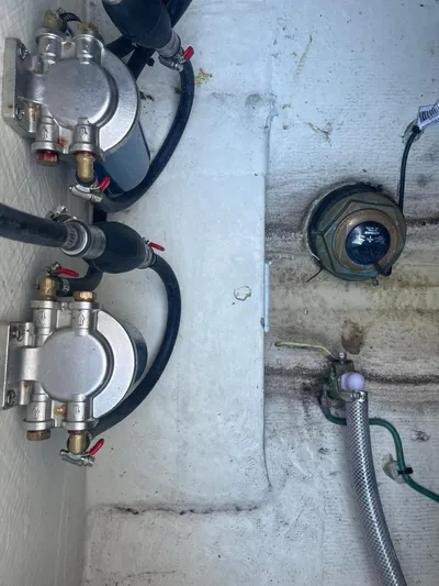  Yacht Photos Pics 2023 Cobia 320 CC boat components, featuring fuel filters and hoses in the engine compartment.