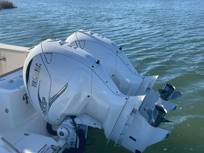  Yacht Photos Pics 2023 Cobia 320 CC boat with twin Yamaha outboard engines on water.