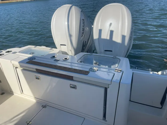  Yacht Photos Pics 2023 Cobia 320 CC boat with dual Yamaha engines on water.