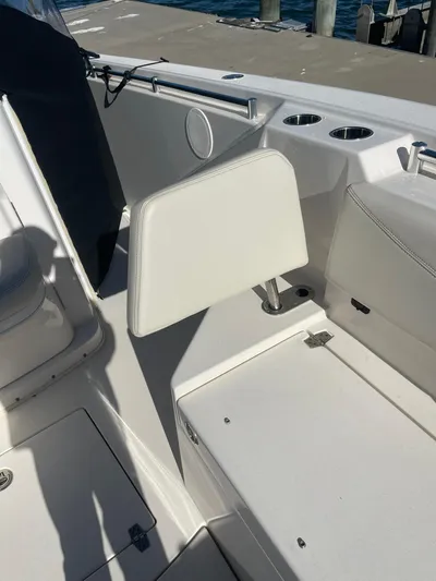  Yacht Photos Pics 2023 Cobia 320 CC boat interior with white seating and cup holders.