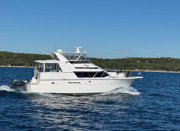  Yacht Photos Pics 1994 Hatteras 48 Cockpit MY yacht cruising on blue water under clear sky.
