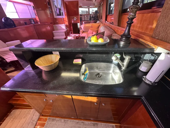  Yacht Photos Pics Luxurious kitchen interior of 1994 Hatteras 48 Cockpit MY yacht with sleek countertops.