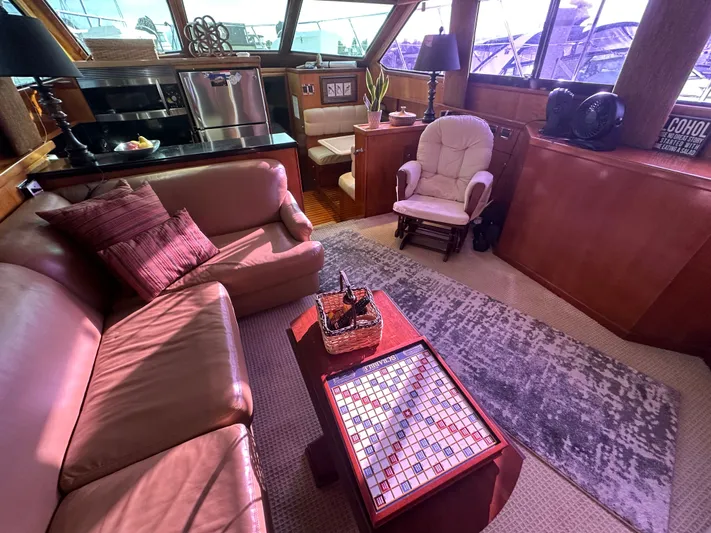  Yacht Photos Pics Luxurious interior of 1994 Hatteras 48 Cockpit MY yacht with cozy seating and Scrabble game.
