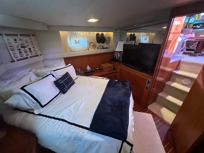  Yacht Photos Pics Luxurious bedroom interior of 1994 Hatteras 48 Cockpit MY yacht with elegant bedding and decor.