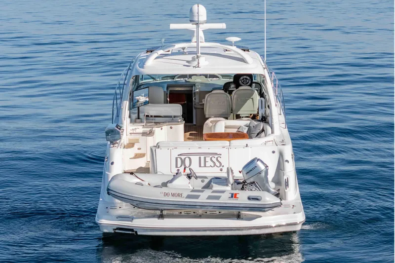 Do Less Yacht Photos Pics 2007 Sea Ray 48 Sundancer yacht on calm water, rear view with dinghy attached.