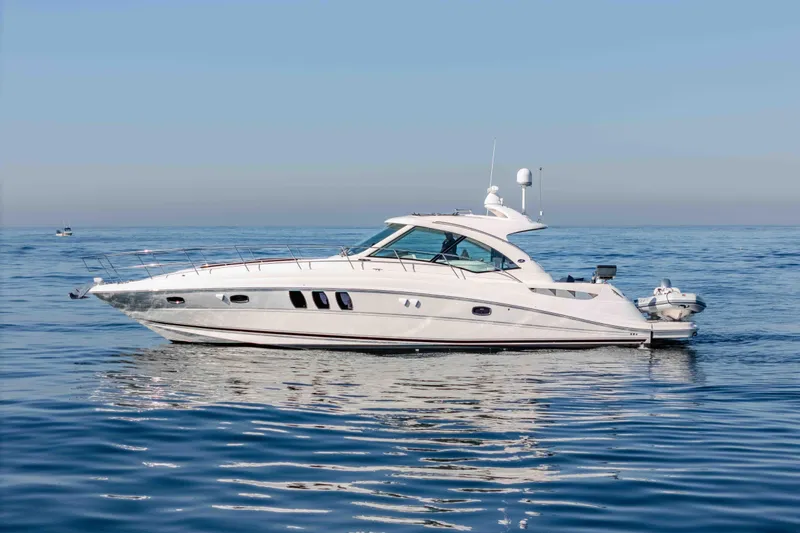 Do Less Yacht Photos Pics 2007 Sea Ray 48 Sundancer yacht cruising on calm blue waters.