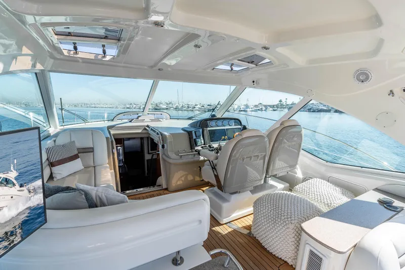 Do Less Yacht Photos Pics Luxurious interior of 2007 Sea Ray 48 Sundancer yacht with panoramic windows and plush seating.