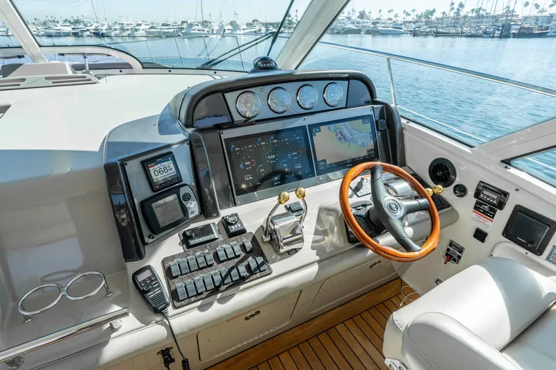 Do Less Yacht Photos Pics 2007 Sea Ray 48 Sundancer helm with advanced navigation and control systems, overlooking marina.
