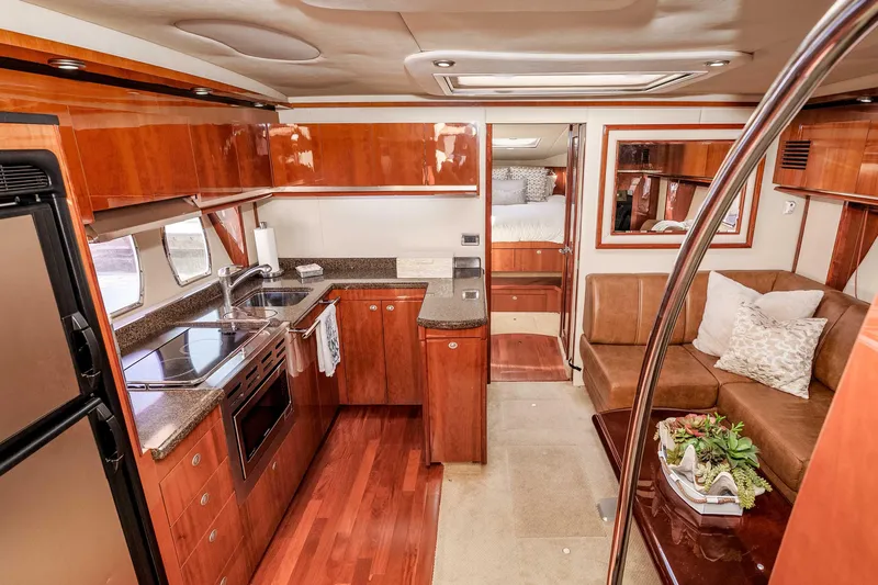 Do Less Yacht Photos Pics Luxurious 2007 Sea Ray 48 Sundancer yacht interior with modern kitchen and cozy seating area.