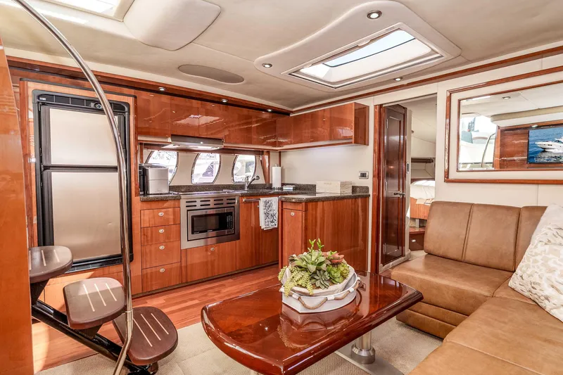 Do Less Yacht Photos Pics Luxurious interior of 2007 Sea Ray 48 Sundancer yacht with modern kitchen and seating area.