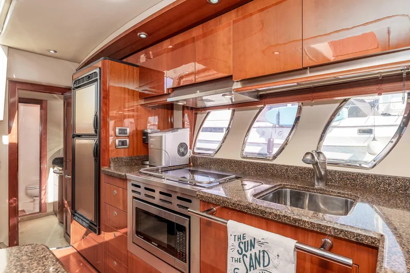Do Less Yacht Photos Pics Luxurious 2007 Sea Ray 48 Sundancer yacht kitchen with modern appliances and sleek wood cabinetry.